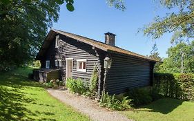 Open wooden chalet built against a hill